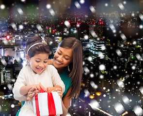 Image showing happy mother and little girl with gift box