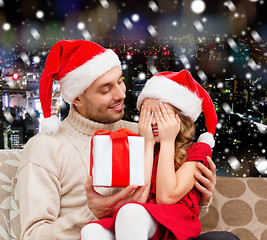 Image showing smiling daughter waiting for present from father