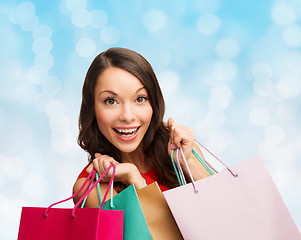 Image showing smiling woman with colorful shopping bags