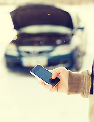 Image showing closeup of man with broken car and cell tphone