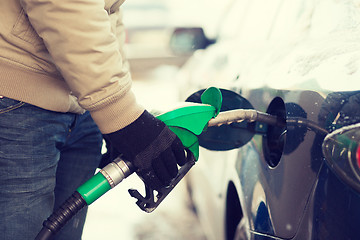 Image showing close up of male refilling car fuel tank