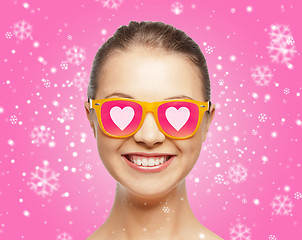 Image showing smiling teenage girl in pink sunglasses