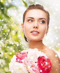 Image showing woman with diamond earrings, ring and flower