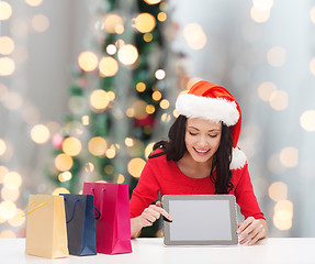 Image showing smiling woman with shopping bags and tablet pc