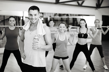 Image showing smiling trainer in front of group of people