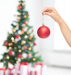 Image showing close up of woman in sweater with christmas ball