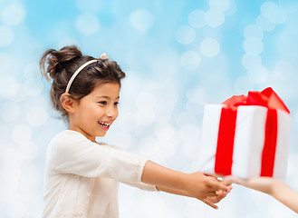 Image showing smiling little girl with gift box