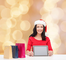 Image showing smiling woman with shopping bags and tablet pc