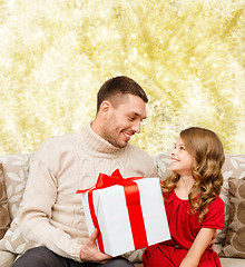 Image showing smiling father and daughter with gift box