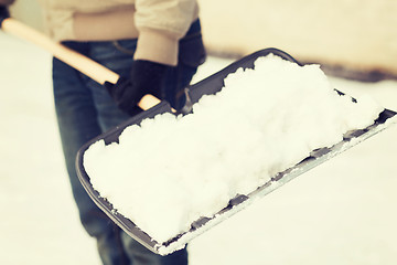 Image showing closeup of man shoveling snow from driveway