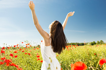 Image showing young woman on poppy field