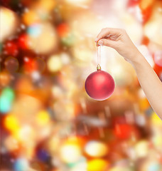 Image showing close up of woman in sweater with christmas ball