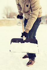 Image showing closeup of man shoveling snow from driveway