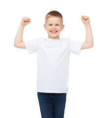 Image showing little boy in blank white t-shirt showing muscles