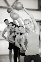 Image showing group of smiling people working out with ball