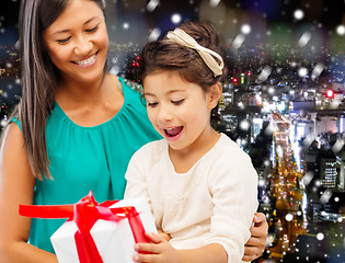 Image showing happy mother and little girl with gift box