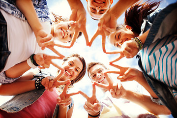 Image showing group of teenagers showing finger five