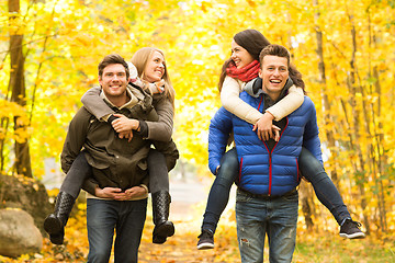 Image showing smiling friends having fun in autumn park