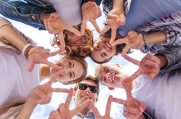 Image showing group of teenagers showing finger five