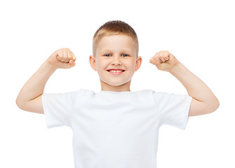 Image showing little boy in blank white t-shirt showing muscles