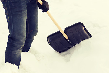 Image showing closeup of man shoveling snow from driveway