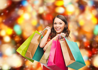 Image showing smiling woman with colorful shopping bags