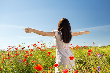 Image showing young woman on poppy field