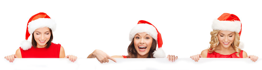 Image showing women in santa helper hat with blank white board