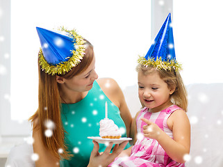 Image showing mother and daughter in party hats with cake