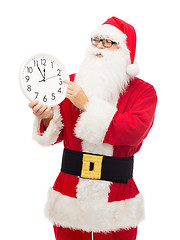 Image showing man in costume of santa claus with clock