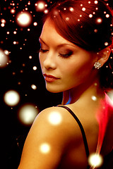 Image showing woman in evening dress wearing diamond earrings