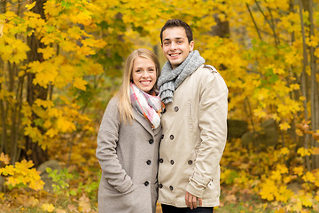 Image showing smiling couple hugging in autumn park