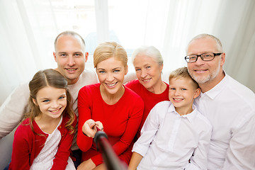 Image showing smiling family taking selfie at home