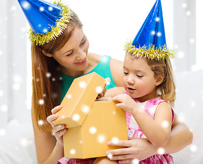 Image showing mother and daughter in party hats with gift box