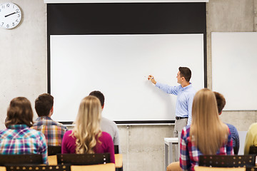 Image showing group of students and smiling teacher in classroom