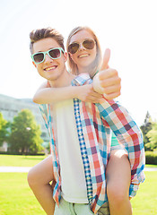 Image showing smiling couple having fun and showing thumbs up