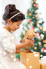 Image showing smiling little girl with gift box and teddy bear