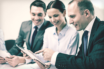 Image showing business team with tablet pc having discussion