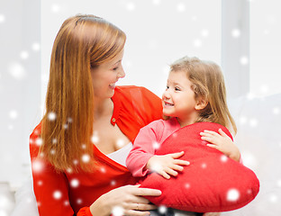 Image showing mother and daughter with heart shape pillow