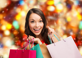 Image showing smiling woman with colorful shopping bags