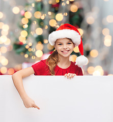 Image showing girl in santa helper hat with blank white board