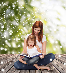 Image showing happy mother with little girl and book