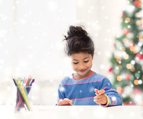 Image showing smiling little girl with pencils drawing at home