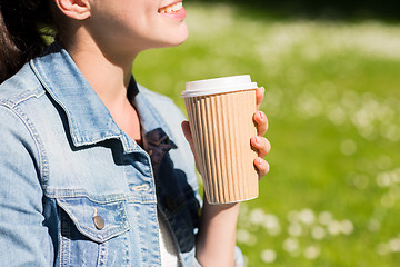 Image showing close up of smiling girl with coffee cup outdoors