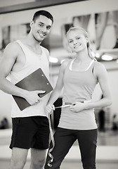 Image showing two smiling people with clipboard and measure tape