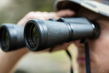 Image showing close up of soldier or hunter with binocular