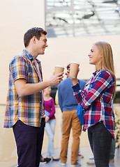 Image showing group of smiling students with paper coffee cups