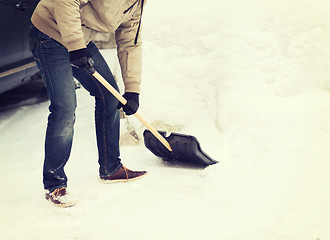 Image showing closeup of man shoveling snow from driveway