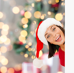 Image showing woman in santa helper hat with blank white board