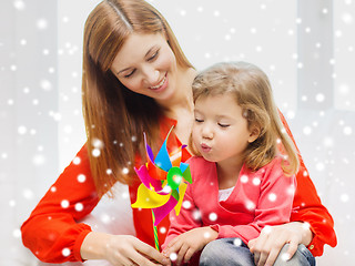 Image showing mother and daughter with pinwheel